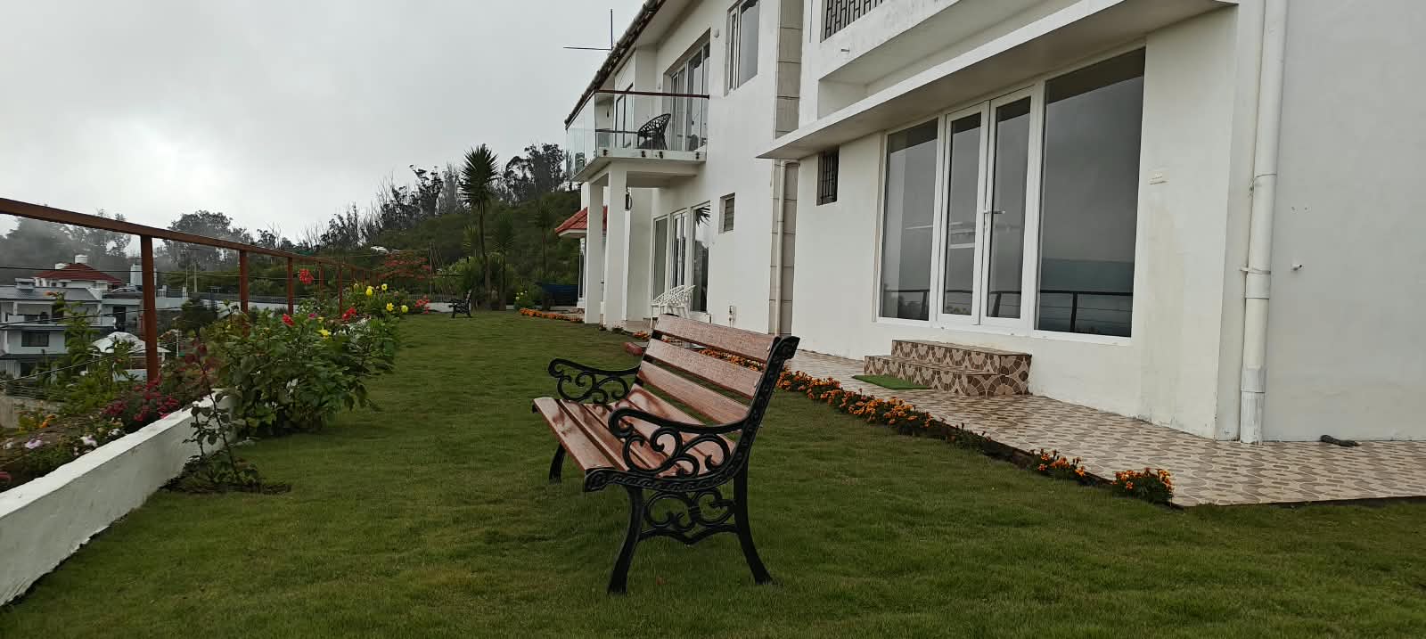 The lower lawn with stepping stones across the grass, flower beds either side
